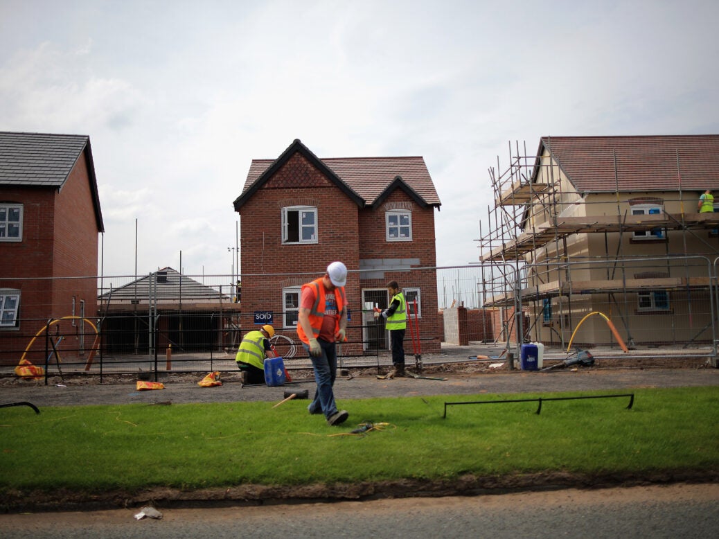 Construction workers build housing in England